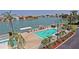 Aerial view of a community pool, surrounded by lush landscaping and waterfront access at 6060 Shore S Blvd # 903, Gulfport, FL 33707