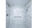 Modern shower featuring marble-patterned tile and a convenient grab bar for added safety and accessibility at 6060 Shore S Blvd # 903, Gulfport, FL 33707