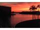 Stunning sunset view overlooking the serene waterway and swaying palms at 6060 Shore S Blvd # 903, Gulfport, FL 33707