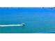 Expansive water view features a boat speeding in the clear blue water at 6060 Shore S Blvd # 903, Gulfport, FL 33707