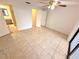 Neutral bedroom with tiled floor, ceiling fan, closet and adjacent bathroom at 613 Sandy Hollow Rd, Tarpon Springs, FL 34689