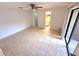 Open bedroom with tiled floor, fan, and natural light from sliding glass door at 613 Sandy Hollow Rd, Tarpon Springs, FL 34689