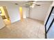 Neutral bedroom with tiled floor, ceiling fan, closet and adjacent bathroom at 613 Sandy Hollow Rd, Tarpon Springs, FL 34689
