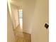 Hallway with tile floors leading to a bedroom and bathroom at 613 Sandy Hollow Rd, Tarpon Springs, FL 34689