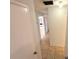 Neutral hallway featuring tiled floor and view through to another room at 613 Sandy Hollow Rd, Tarpon Springs, FL 34689