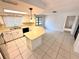 Bright kitchen featuring white cabinets, tile backsplash, and a breakfast bar with pendant lighting at 613 Sandy Hollow Rd, Tarpon Springs, FL 34689