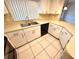 Kitchen with white cabinets, double sink, and modern appliances for convenient cooking at 613 Sandy Hollow Rd, Tarpon Springs, FL 34689