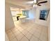 Bright kitchen with white cabinets, breakfast bar, and tile floors, open to dining area with natural light at 613 Sandy Hollow Rd, Tarpon Springs, FL 34689