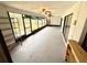 Enclosed lanai with ceiling fans, offering a versatile space for relaxation and entertainment at 613 Sandy Hollow Rd, Tarpon Springs, FL 34689