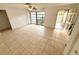 Bright living room with tile flooring, ceiling fan, and a front door at 613 Sandy Hollow Rd, Tarpon Springs, FL 34689