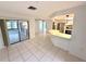 Spacious living room with access to a screened lanai and open-concept kitchen at 613 Sandy Hollow Rd, Tarpon Springs, FL 34689