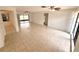 Spacious living room with tile flooring, ceiling fans, and sliding glass doors to the backyard at 613 Sandy Hollow Rd, Tarpon Springs, FL 34689