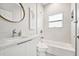 Bright bathroom with a white vanity, modern fixtures, and tiled shower/tub combination at 6433 Werner Ave, New Port Richey, FL 34652