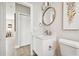 Powder room featuring a modern vanity with round mirror and decorative wall art at 6433 Werner Ave, New Port Richey, FL 34652