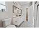 Modern bathroom features a double sink vanity with mosaic tile flooring and neutral paint at 6433 Werner Ave, New Port Richey, FL 34652