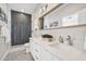Elegant bathroom featuring a shower with stylish tile, dual sinks, and modern lighting at 6433 Werner Ave, New Port Richey, FL 34652