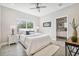 Bright bedroom with white bedding, plush rug, and ensuite bathroom access at 6433 Werner Ave, New Port Richey, FL 34652