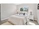 Well-lit bedroom featuring a cozy bed, stylish side tables, and a large window view at 6433 Werner Ave, New Port Richey, FL 34652