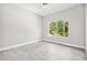 Bright and airy bedroom with a large window offering scenic outdoor views at 6433 Werner Ave, New Port Richey, FL 34652