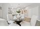 Dining area featuring hardwood floors with a modern glass table at 6433 Werner Ave, New Port Richey, FL 34652