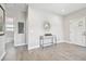 Hallway showing the hardwood floors and access to the Primary bathroom at 6433 Werner Ave, New Port Richey, FL 34652