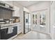 The modern kitchen has stainless appliances, access to a covered patio, and tile floors at 6433 Werner Ave, New Port Richey, FL 34652