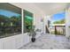 Charming tiled porch with white trim, providing a welcoming entrance to the home and views of the neighborhood at 6433 Werner Ave, New Port Richey, FL 34652