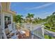 Enjoy neighborhood views from this balcony featuring white rocking chairs and table at 6468 Rubia Cir, Apollo Beach, FL 33572