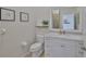 Well-lit bathroom with a white vanity, marble countertop, and decorative wall art at 6468 Rubia Cir, Apollo Beach, FL 33572