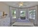 Bright bedroom with many windows, light colored dresser, and white metal bedframe at 6468 Rubia Cir, Apollo Beach, FL 33572