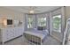 Bright bedroom with many windows, light colored dresser, and white metal bedframe at 6468 Rubia Cir, Apollo Beach, FL 33572