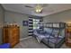 A bedroom featuring a bunk bed, wooden dresser, and grey walls at 6468 Rubia Cir, Apollo Beach, FL 33572