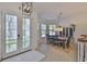 Bright dining room with tile floors, French doors, a wooden dining table, and large windows at 6468 Rubia Cir, Apollo Beach, FL 33572