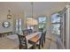 Dining room with a view to the outside, complemented by a large window and a wooden table with six chairs at 6468 Rubia Cir, Apollo Beach, FL 33572