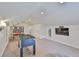 A large game room with foosball table, study area, media center, and carpet flooring at 6468 Rubia Cir, Apollo Beach, FL 33572