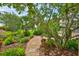 Stone path through lush tropical garden landscaping at 6468 Rubia Cir, Apollo Beach, FL 33572