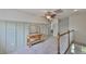 Upstairs landing features grey wainscotting, carpet and a vintage wooden table at 6468 Rubia Cir, Apollo Beach, FL 33572