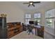 Comfortable home office space with a corner desk setup, ample storage, and natural light from the window at 6468 Rubia Cir, Apollo Beach, FL 33572