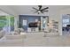 Comfortable living room featuring a blue accent wall, oversized sectional, and sliding glass doors at 6468 Rubia Cir, Apollo Beach, FL 33572