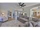 Living room featuring a large sectional sofa, tile floors, and an open floor plan at 6468 Rubia Cir, Apollo Beach, FL 33572