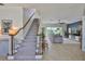 View of a living room with a staircase, tile floors, and an open floor plan at 6468 Rubia Cir, Apollo Beach, FL 33572