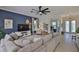 Spacious living room features a large sectional sofa, a ceiling fan, and neutral decor at 6468 Rubia Cir, Apollo Beach, FL 33572