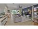 Spacious living room featuring tile flooring, a ceiling fan, and a comfortable gray sectional sofa at 6468 Rubia Cir, Apollo Beach, FL 33572