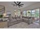 View of living room with an open floor plan to the kitchen and outdoor views of the pool at 6468 Rubia Cir, Apollo Beach, FL 33572