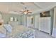 Spacious main bedroom with tray ceiling, ceiling fan, dresser with mirror, and TV at 6468 Rubia Cir, Apollo Beach, FL 33572