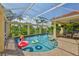 Screened-in pool with a brick deck, outdoor seating, and surrounding tropical foliage at 6468 Rubia Cir, Apollo Beach, FL 33572