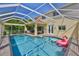 Screened pool area with patio, outdoor seating, and sunny backyard views at 6468 Rubia Cir, Apollo Beach, FL 33572