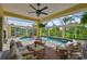 An enclosed pool and patio area with outdoor seating and tropical landscaping at 6468 Rubia Cir, Apollo Beach, FL 33572