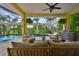 Relaxing screened-in pool area with outdoor seating, grill, and lush tropical surroundings at 6468 Rubia Cir, Apollo Beach, FL 33572