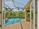 Enclosed swimming pool featuring brick flooring and tropical views at 6468 Rubia Cir, Apollo Beach, FL 33572